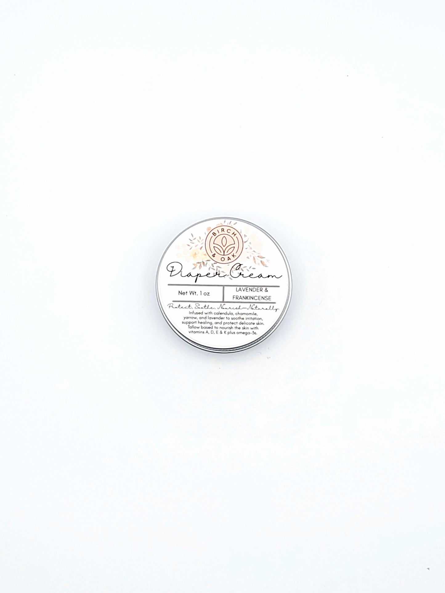 Round container of diaper cream on a white background