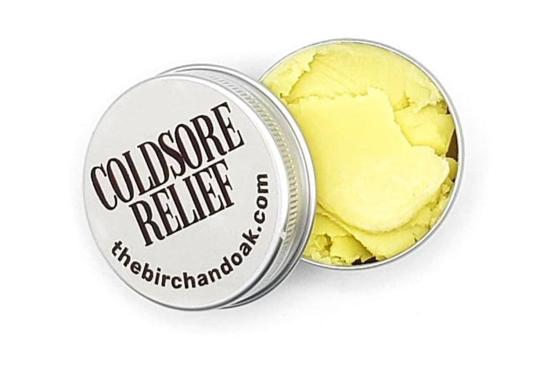 Coldsore relief product with yellow gel in a round container on a white background