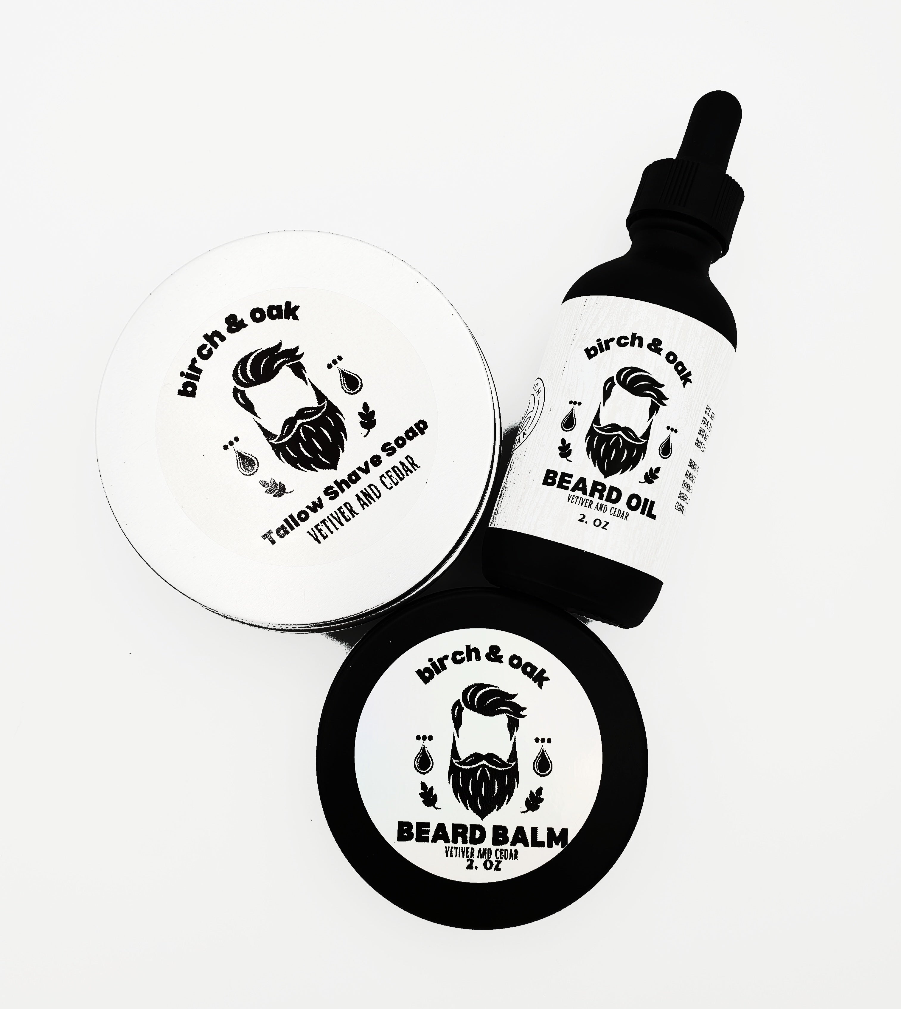 A bottle of Birch & Oak Beard Oil and a container of Beard Balm, both with white labels featuring a mustache and the names of the products.