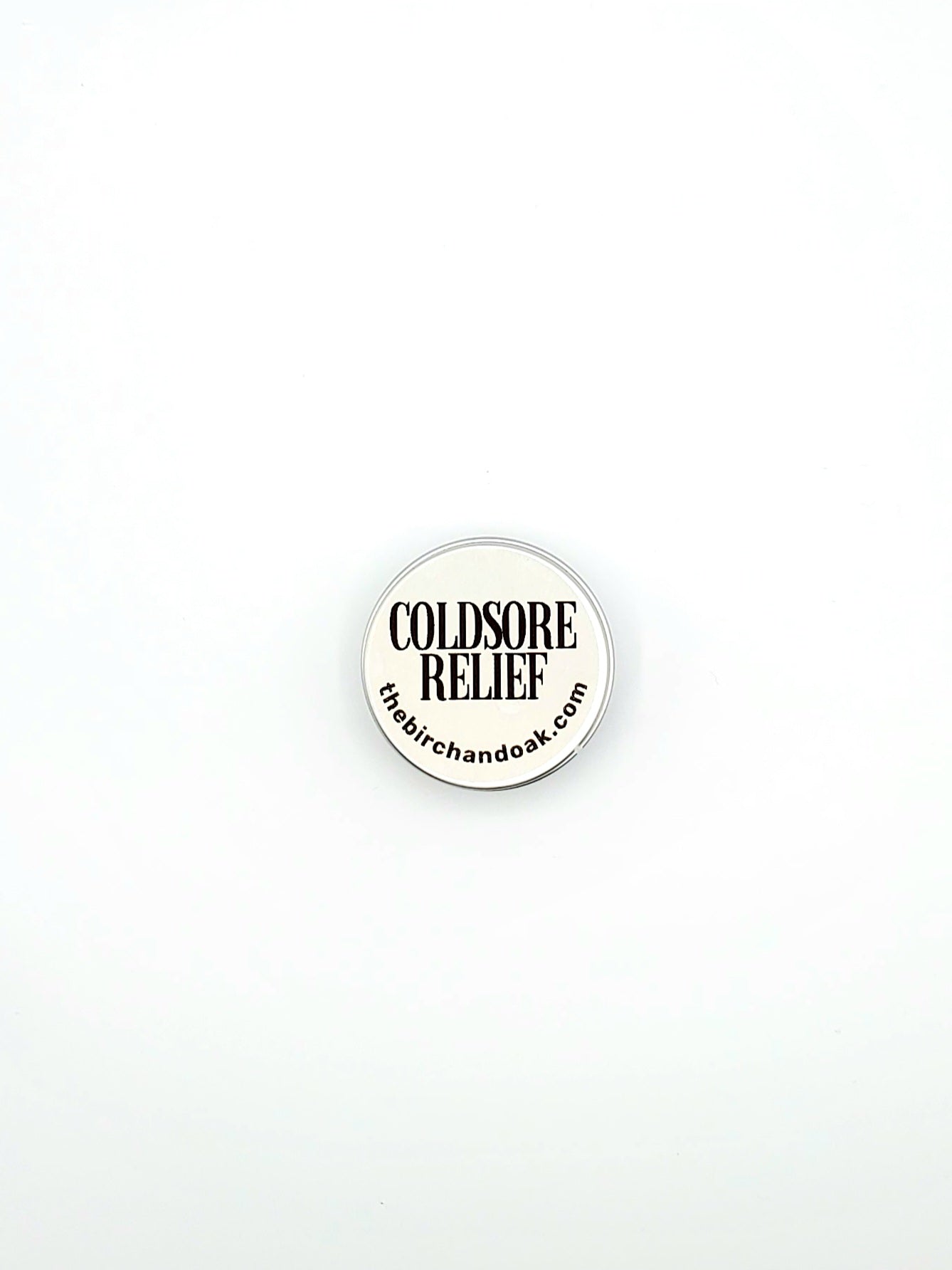Round white sticker with 'Coldsore Relief' text on a white background