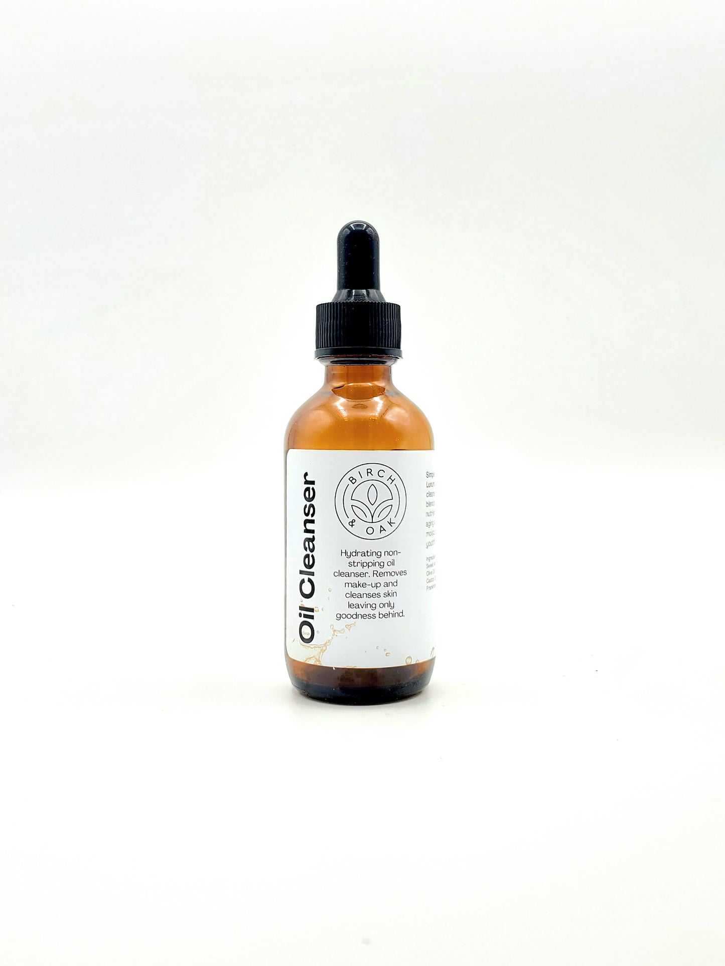 Bottle of Oil Cleanser with a white label on a light gray background