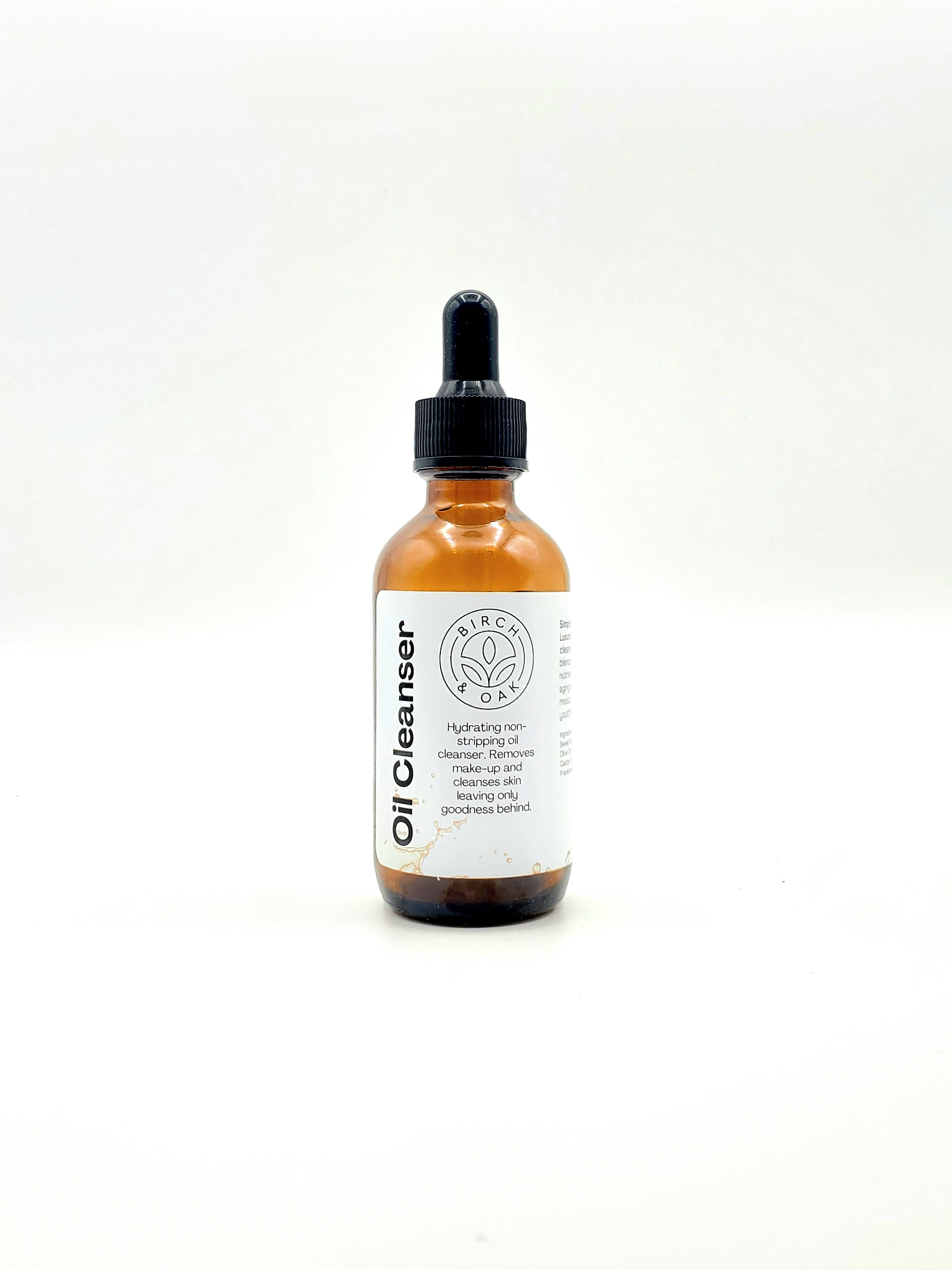 Bottle of Oil Cleanser with a white label on a light gray background