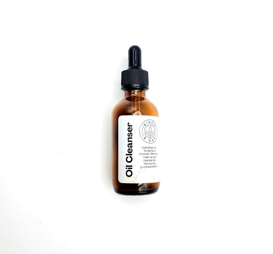 Bottle of Oil Cleanser with a white label on a light gray background